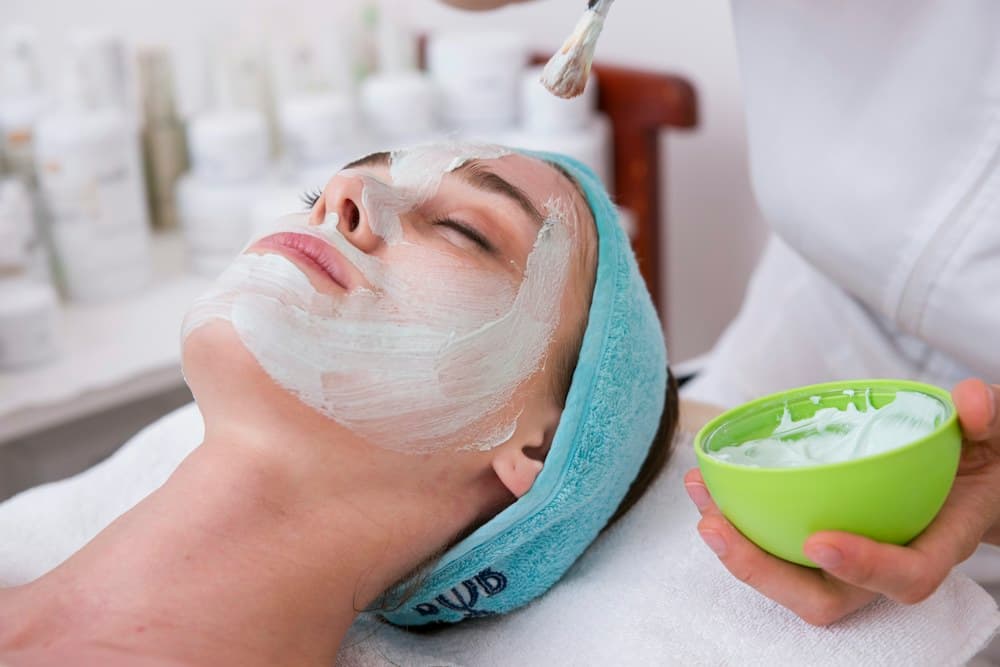 Tratamiento facial profesional con luz natural y tonos blancos